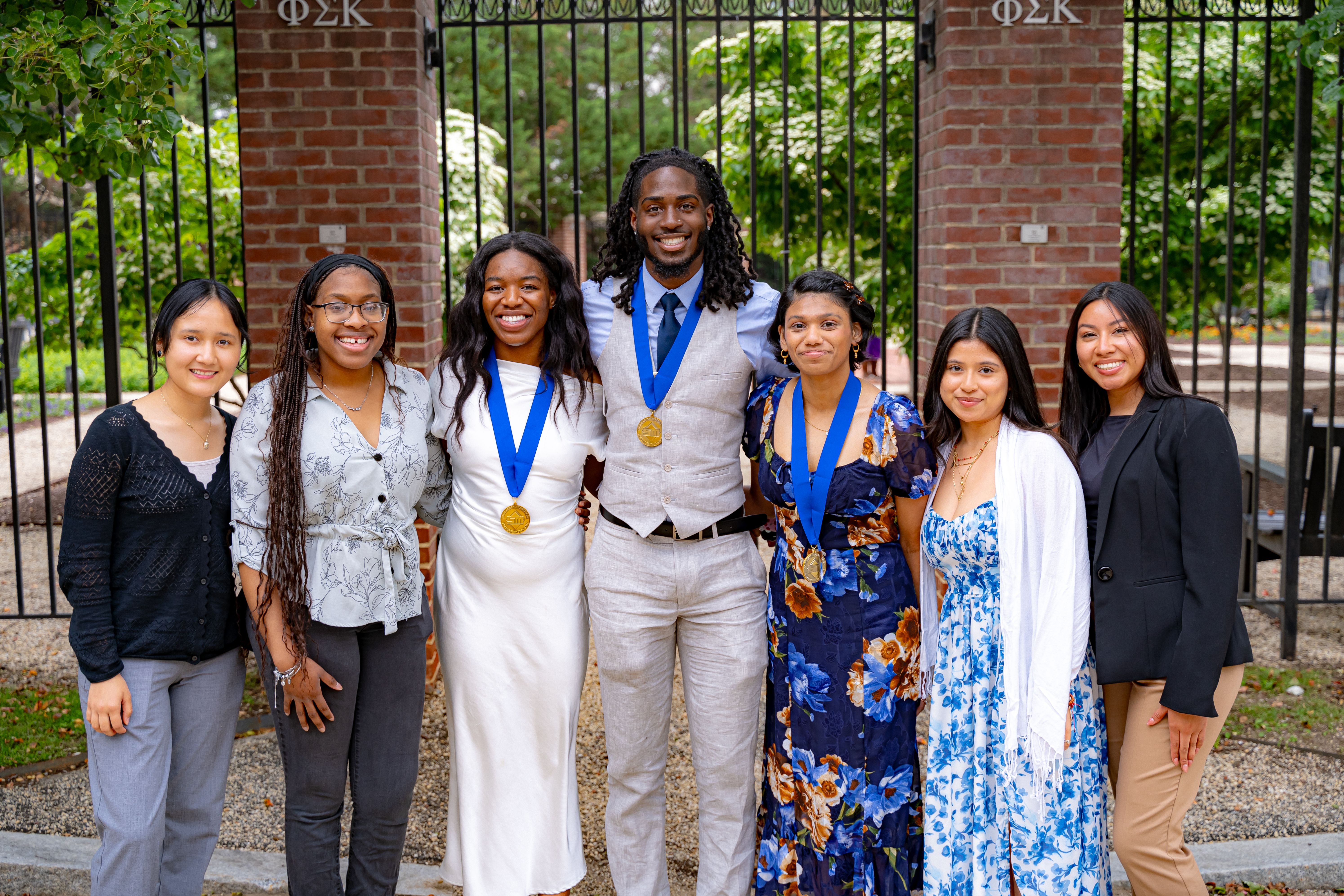 group of students and alum after ceremony smilingg